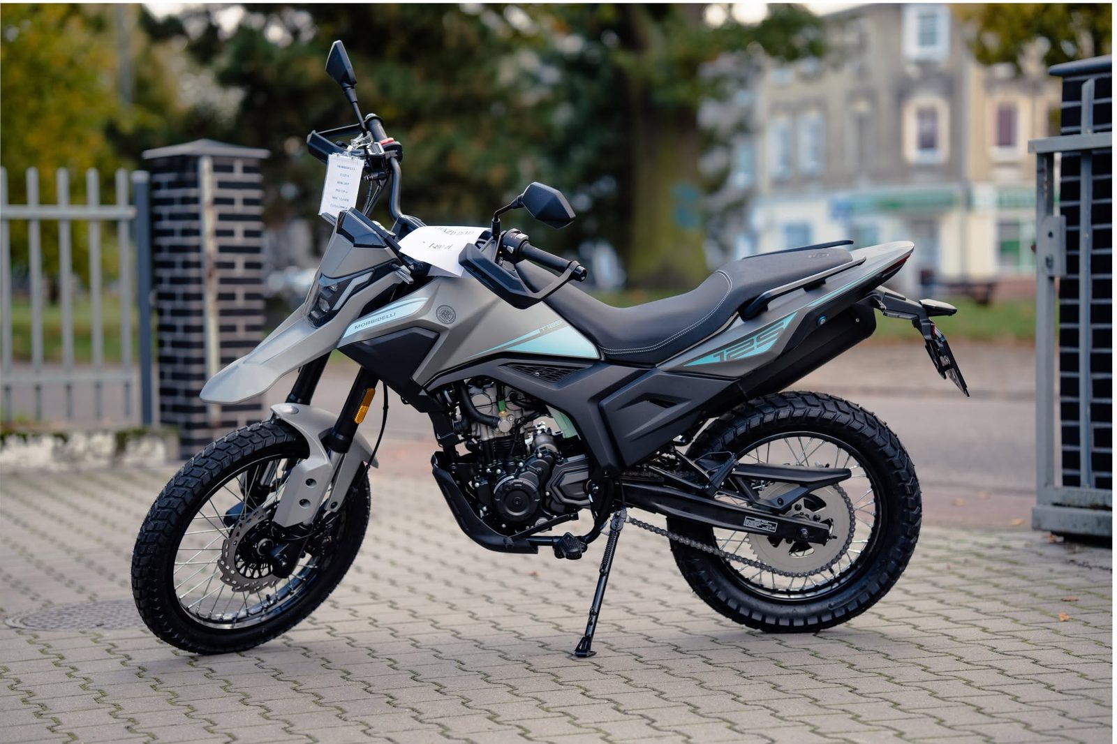 Szaro-czarny motocykl zaparkowany na chodniku